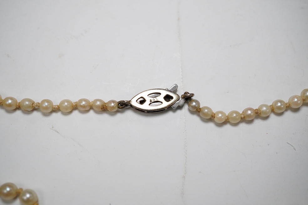 A single strand graduated cultured pearl necklace, with gem set 9ct clasp, 48cm. Condition - fair